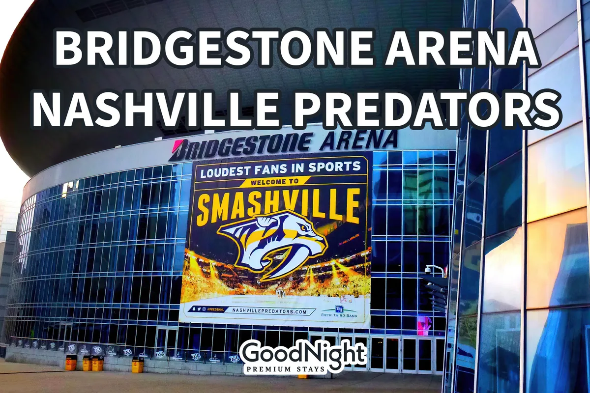 The illuminated exterior of Bridgestone Arena displays the Nashville Predators logo and a prominent 'Welcome to Smashville' banner. The downtown setting buzzes with visitors attending concerts, hockey games, and events, reflecting the city’s reputation for live entertainment.